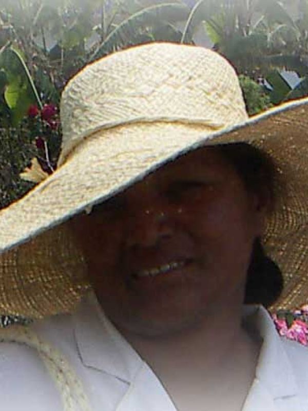 10. Artisan Madame Raton wearing a beautifully wide-brimmed, self-made raffia hat.